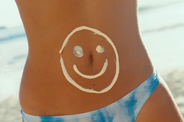 Woman with flat stomach on the beach